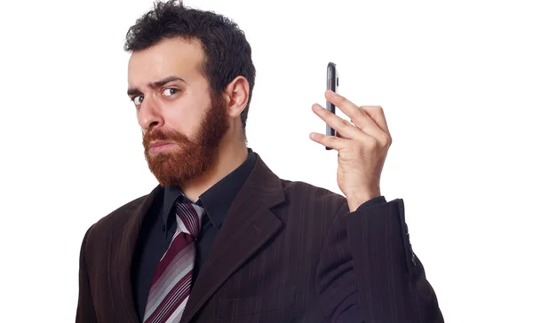 Businessman puts his phone away from his ear — Stock Photo, Image