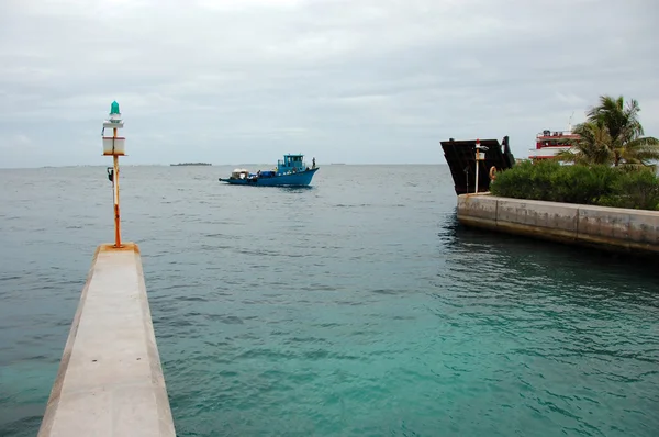 Blue ship at Bandos Island port gate — Stock Photo, Image