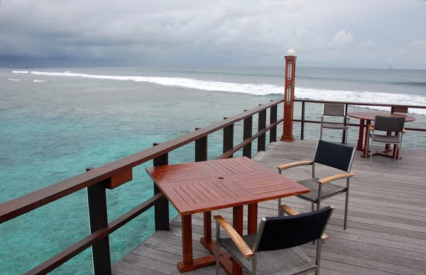 Open air cafe at timber platform with ocean view — Stock Photo, Image