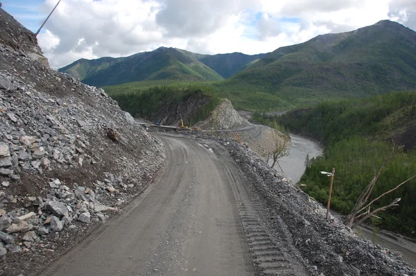 Mountain gravel road turn left — Stock Photo, Image