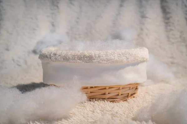 Basket with padding polyester and artificial clouds. Blank for a newbourne photo shoot.