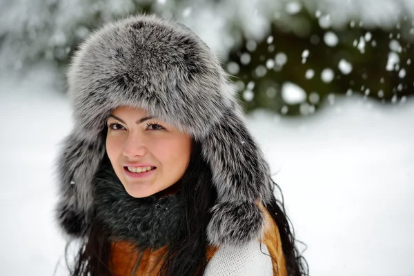 Portrait of beautiful smiling female in luxurious fur head cloth — Stock Photo, Image