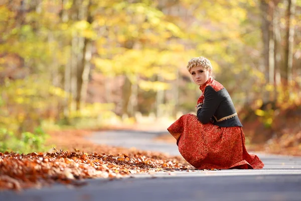 Beautiful elegant blonde woman in autumn forest — Stock Photo, Image