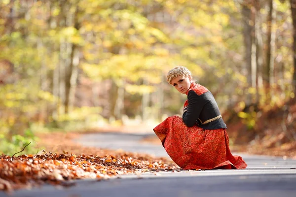 Beautiful elegant blonde woman in autumn forest — Stock Photo, Image