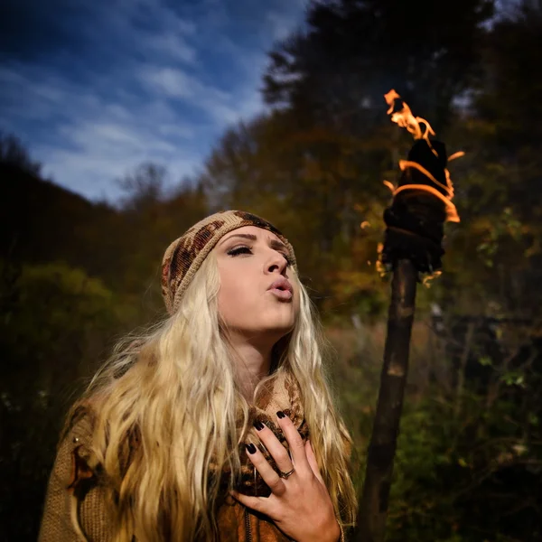 Beautiful young woman outdoor on autumn day holding burning torc — Stock Photo, Image