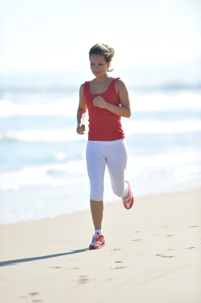 Jovem mulher correndo na praia — Fotografia de Stock
