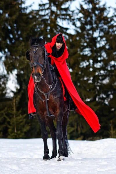 Beautiful woman in red cloak — Stock Photo, Image