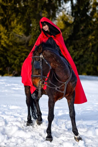 Beautiful woman in red cloak — Stock Photo, Image