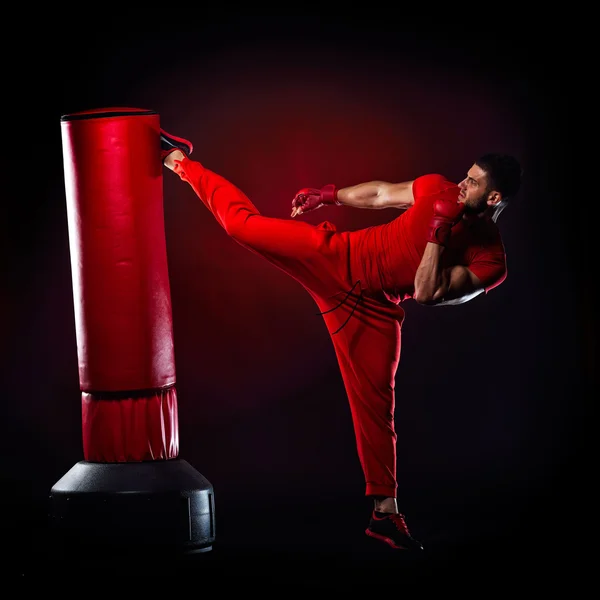 Young man standing by  boxing bag — Stock Photo, Image