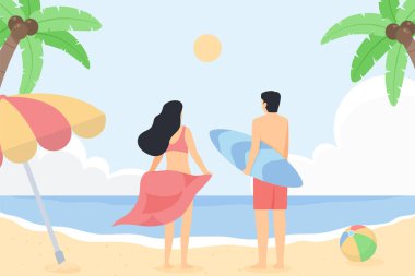 Erkek ve kadın sahilde durur.