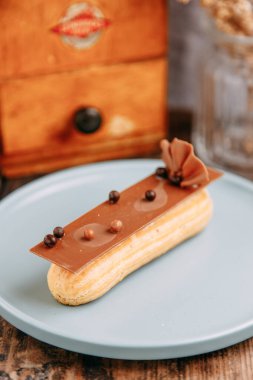 Çikolata ve böğürtlenlerle süslenmiş ekler. Kremalı geleneksel Fransız ekleriName.