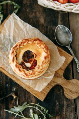 Tahta bir masada sebzeli turta. Sıcak tavuklu börek..