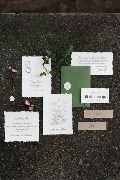 A set of wedding invitations in boho style with calligraphy. Postcard, envelope and card on wedding printing on the background with grass and moss. — Stock Photo, Image