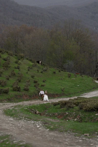 A farm-style wedding on a mountain tea plantation. The couple enjoys the view of nature among the tea plantations.