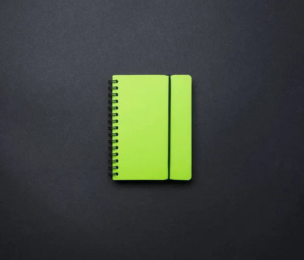 Een open notitieboekje op een zwarte achtergrond bovenaanzicht, een schoolnotitieboekje op een donkere tafel. Plattegrond van het bureau, set artikelen. — Stockfoto