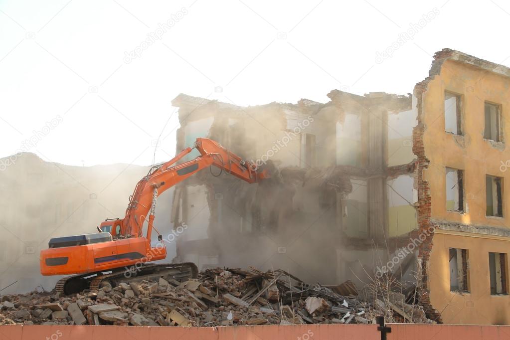 Excavator destroys old house