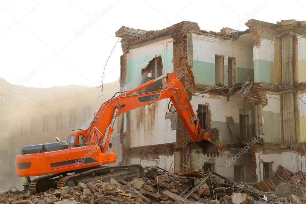 Excavator destroys old house