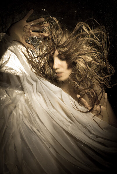 Girl in behind wet glass