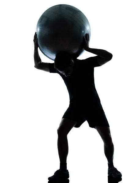 Man workout holding fitness ball silhouette — Stock Photo, Image