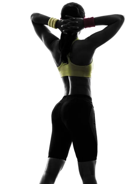 Femme exerçant des bras de fitness derrière la tête silhouette vue arrière — Photo