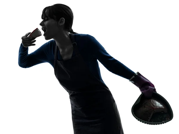 Woman greedy cooking eating chocolate cake — Stock Photo, Image