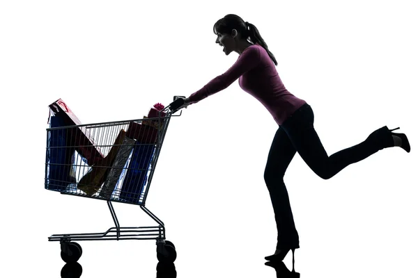 Kvinna med full shopping cart siluett — Stockfoto