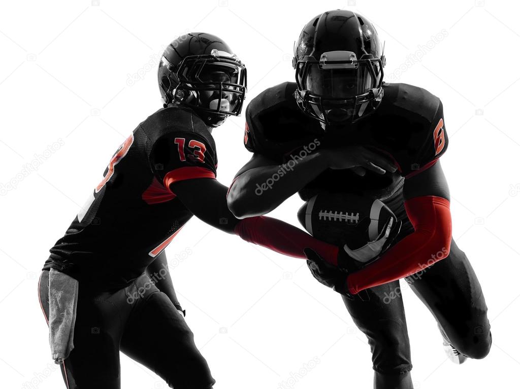 Two american football players passing play action