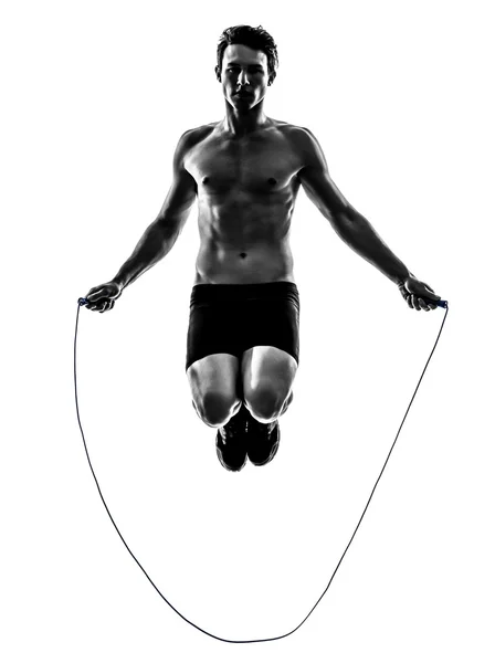 Jonge man uitoefening springen touw silhouet — Stockfoto