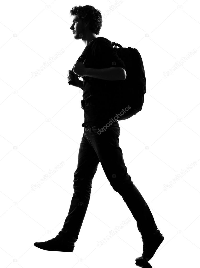 young man silhouette backpacker walking