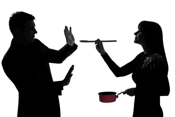 One couple man and woman tasting cooking sauce pan silhouette — Stock Photo, Image