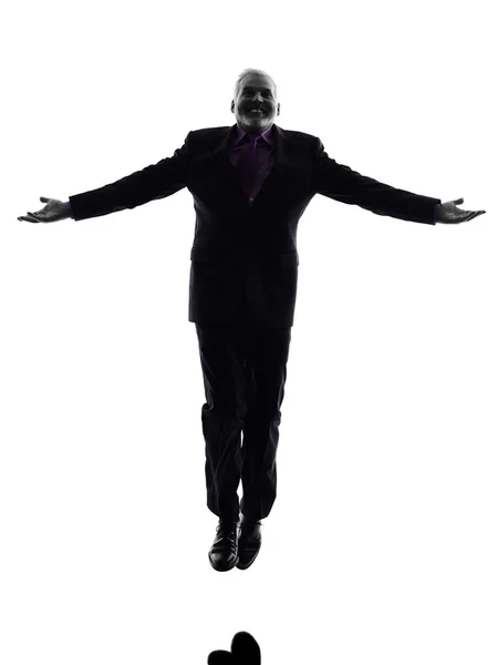 Senior business man jumping arms outstretched silhouette — Stock Photo, Image