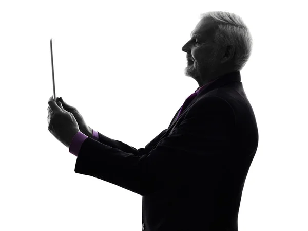 Senior business man holding digital tablet silhouette — Stock Photo, Image