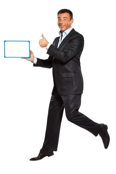 Um homem correndo pulando segurando quadro branco — Fotografia de Stock