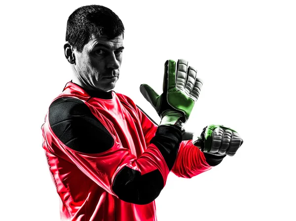Jugador de fútbol caucásico portero hombre ajustando guantes silueta —  Fotos de Stock