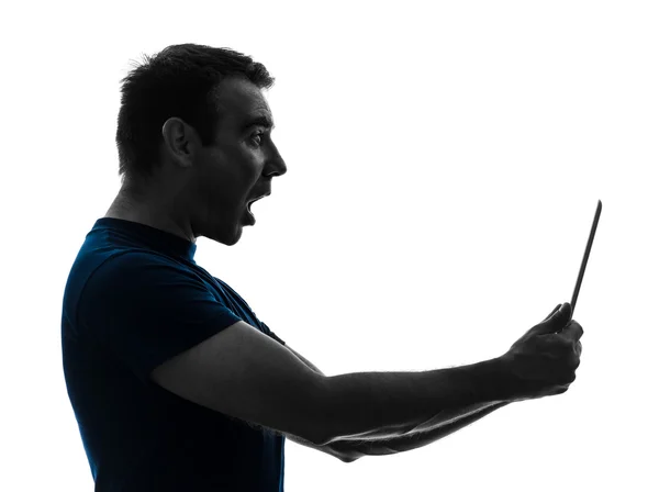 Muž, který držel digitální tabletu překvapený silueta — Stock fotografie