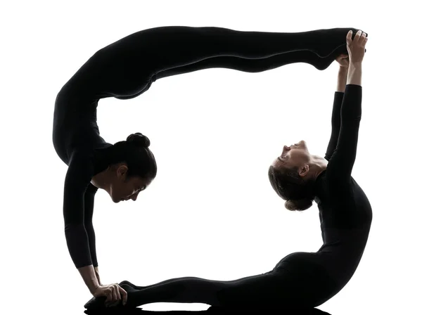 Due donne contorsionista esercizio ginnastica silhouette yoga Immagine Stock