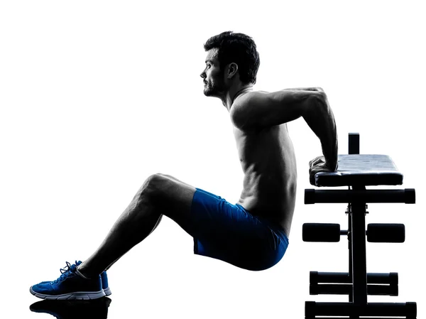 Hombre ejercitando ejercicios de fitness crujidos Banco Prensa ejercicios silueta —  Fotos de Stock