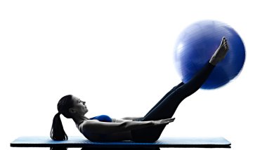 Woman pilates exercising with fitness ball clipart