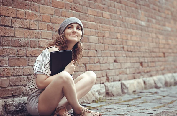 Hipster girl sitting with a laptop — Stock Photo, Image