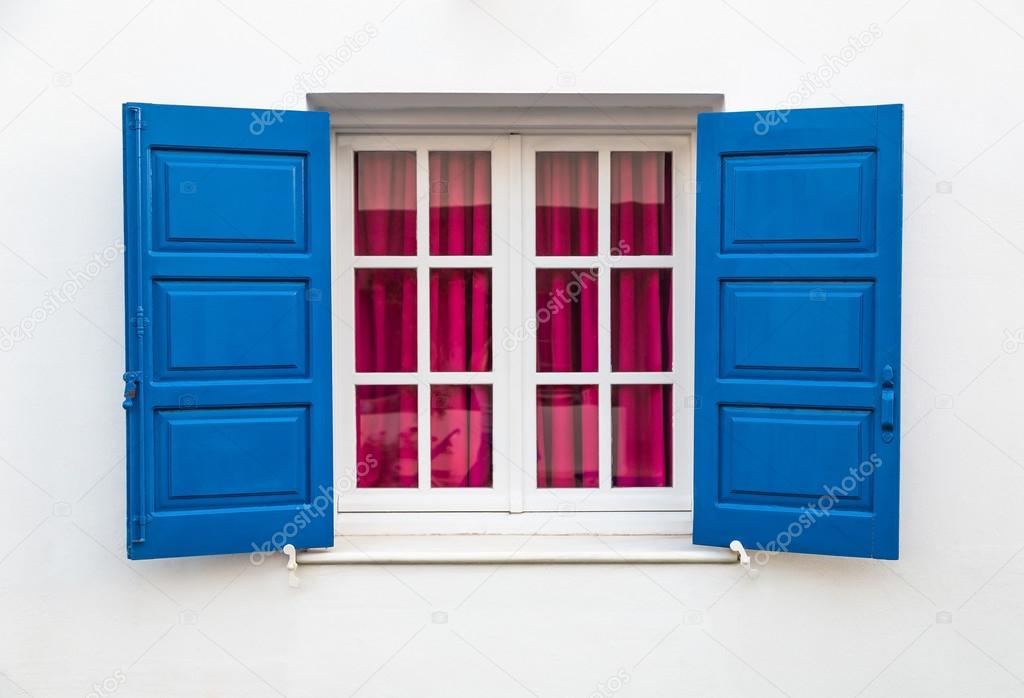 Window on white wall with blue sun blind