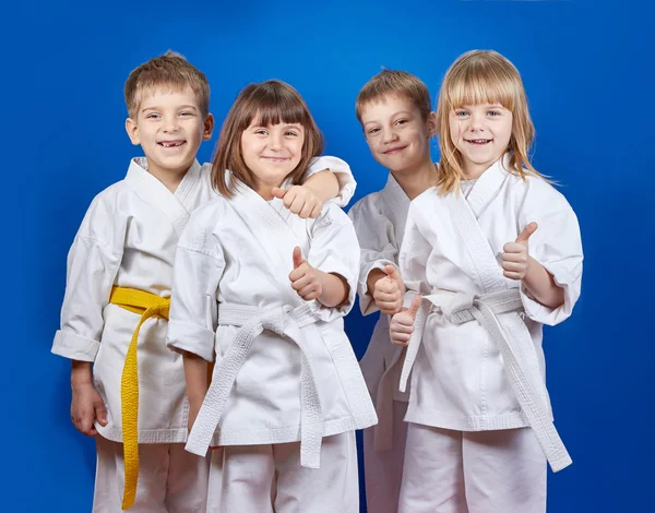 Children in karategi are showing finger super — Stock Photo, Image