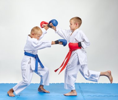 Paired exercise of karate are training athletes with overlays on his hands clipart