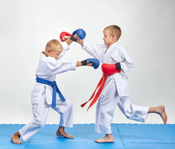 Paired exercise of karate are training athletes with overlays on his hands — Stock Photo, Image