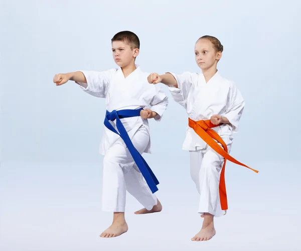 Boy and girl athletes beat punch arm — Stock Photo, Image