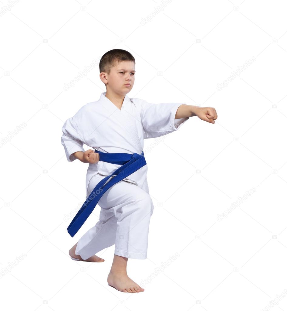 Little karate athlete is beating punch arm isolated