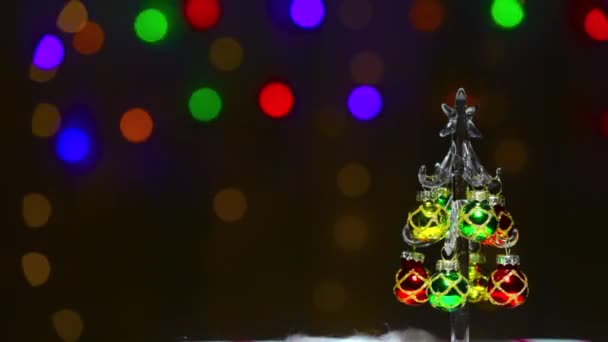 현란하게 빛나는 형형색색의 크리스마스 트리를 배경으로 — 비디오