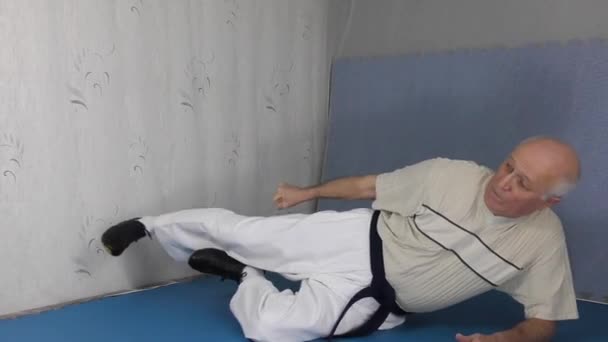 Black Belt Old Man Athlete Training Lying Kicks Tatami — Stock Video