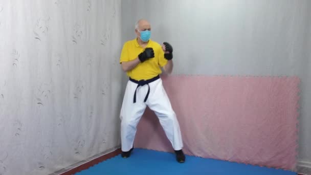 Old Man Athlete Black Pads His Arms Medical Mask Punches — Stock Video