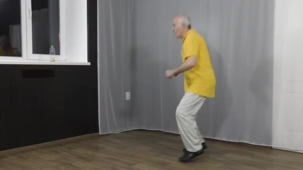 Old Man Athlete Doing Squats Bounces Window — Stock Video