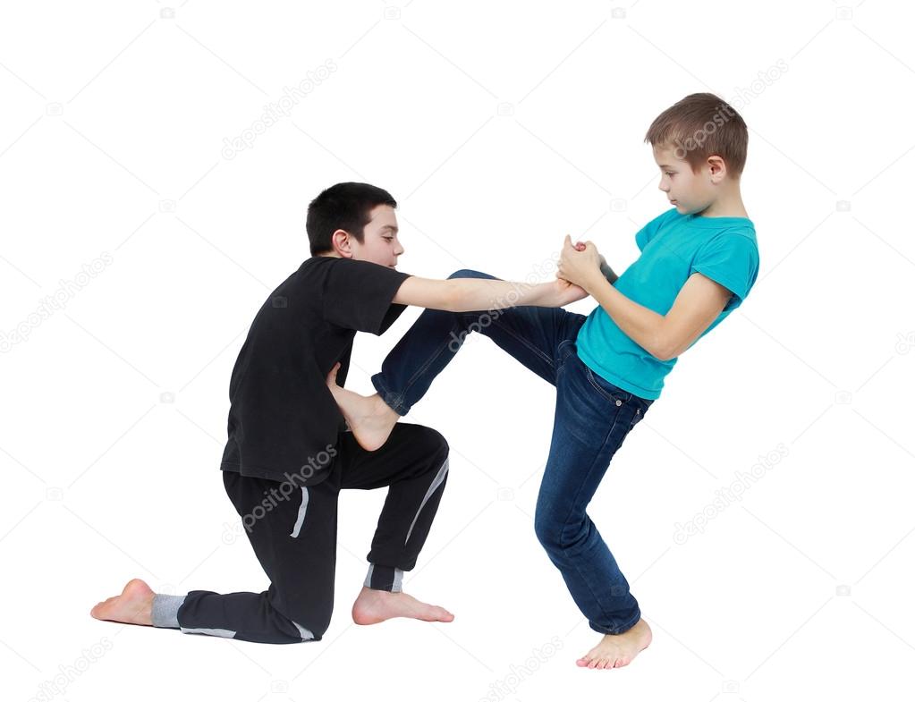 In the blue T-shirt boy is doing armlock on a boy in a black T-shirt